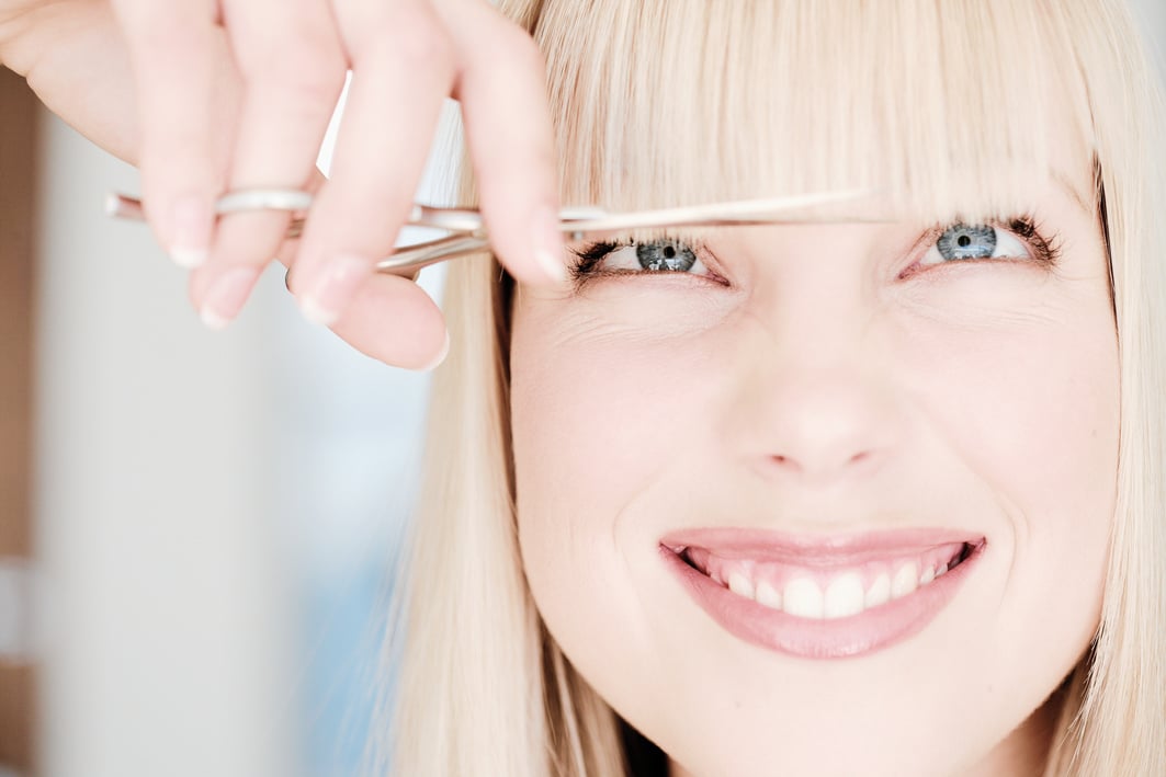 Woman's bangs being trimmed